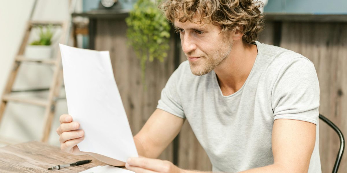 An executive looking frustrated while reviewing documents, reflecting the common challenges businesses face before seeking ops consulting.