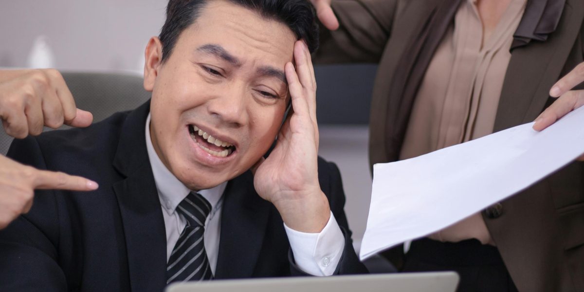 A team looking overwhelmed and stressed in an office setting, illustrating the impact of operational issues on staff.