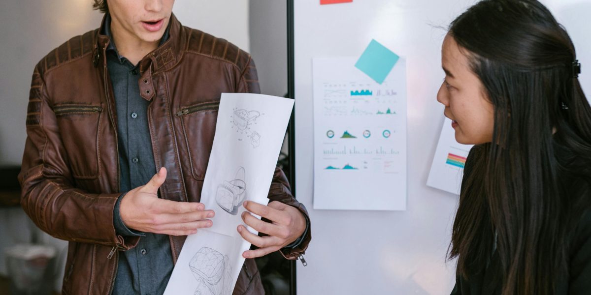 A team collaborating around a whiteboard, actively designing strategies and planning solutions, embodying executive sponsorship and stakeholder involvement.