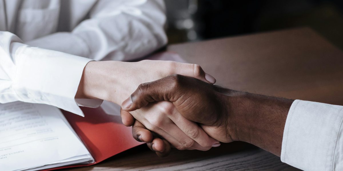 Two professionals conclude a successful meeting with a handshake, symbolizing new opportunities and trust.