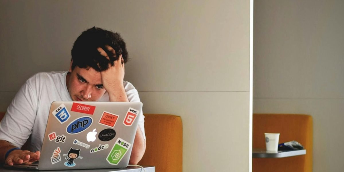 An individual deeply engaged in thought, working through a complex problem, reflecting the challenges of AI development.