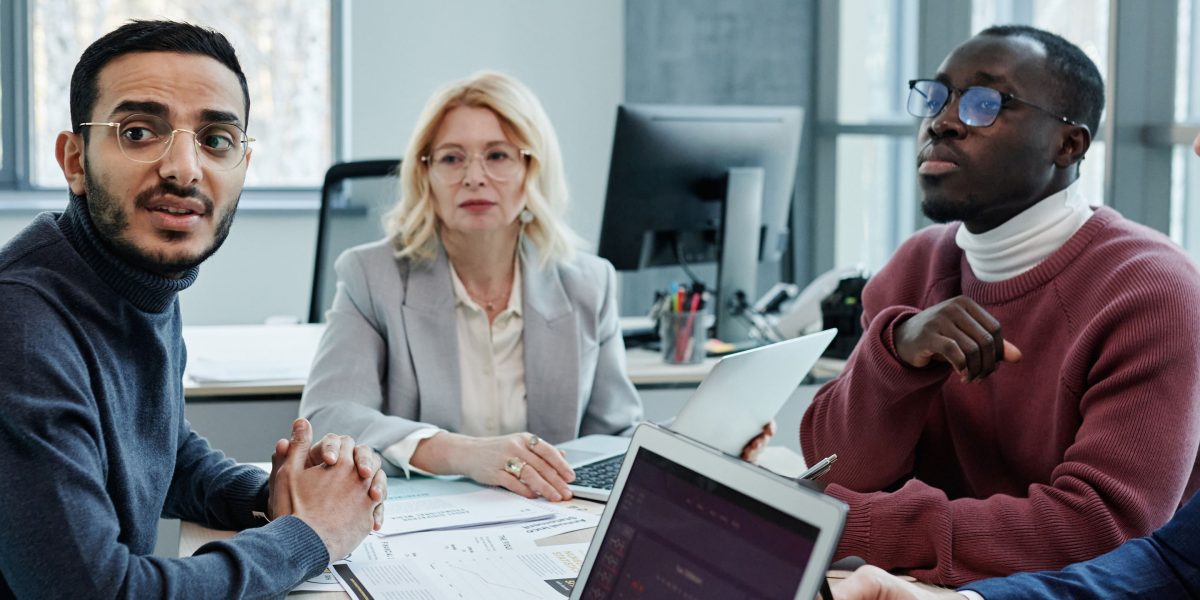 Professionals in a meeting discussing compliance and future-proofing AI systems against evolving regulations and safety standards.