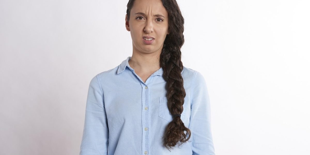 A person looking puzzled or unsure while reviewing content, symbolizing the challenge of identifying subtle AI hallucinations that seem plausible.