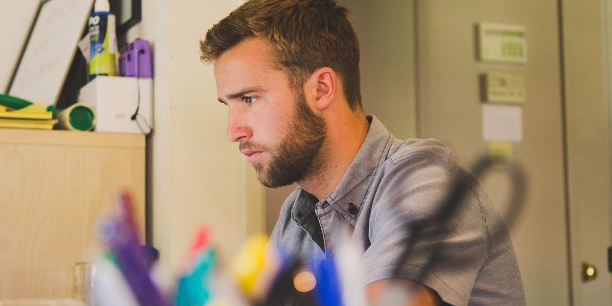 A person in a busy environment attempting to concentrate, reflecting the concept of attentional drift in AI and the challenge of maintaining focus on key details.