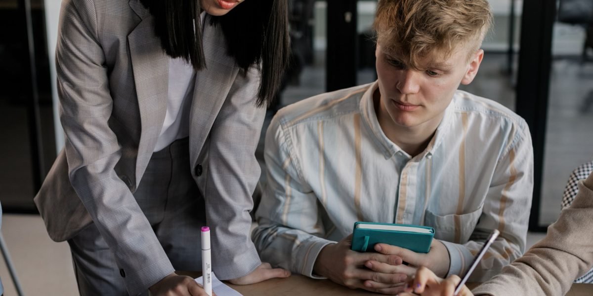 A team actively collaborating, possibly drawing on a whiteboard or brainstorming, to represent the multi-layered 'defense in depth' strategy for AI hallucination mitigation.