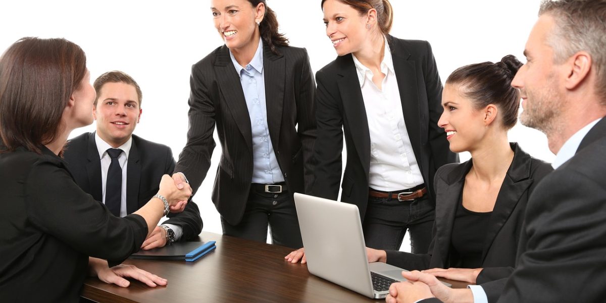 A business team collaborating to review critical documents, emphasizing human oversight.