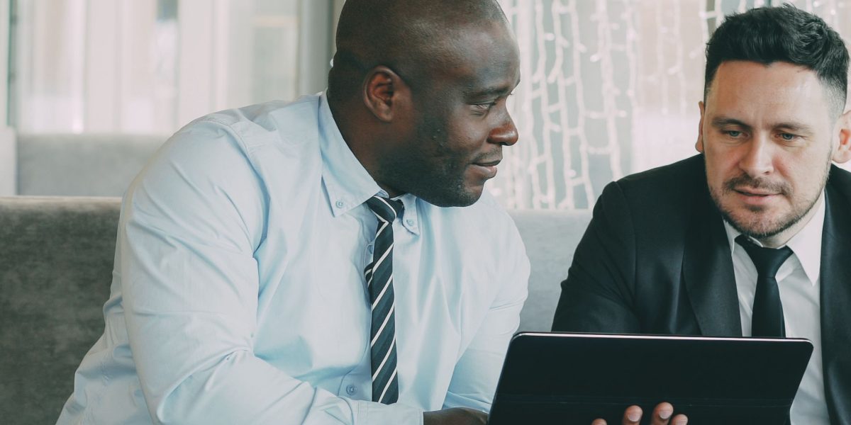 A professional in a modern office environment, focused on reviewing documents or data, symbolizing strategic business planning.
