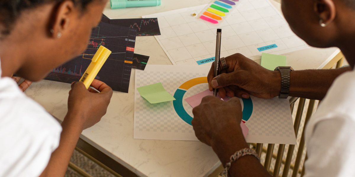 A group of professionals collaborating, using whiteboards and notes to analyze and solve a complex business challenge.
