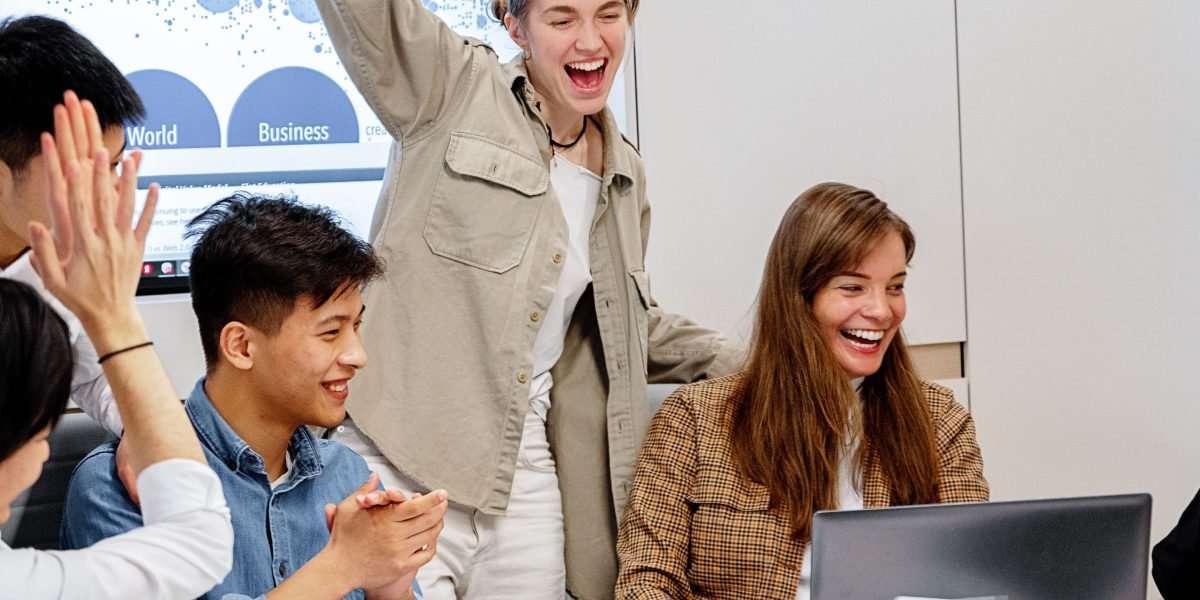 A team celebrates a successful project outcome, reflecting the positive impact of de-risking an AI aggregator with VRS.