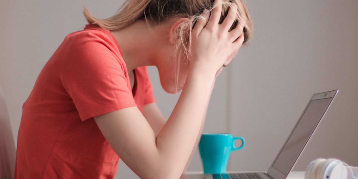 A student looking frustrated, potentially after discovering incorrect information from an AI tool affecting their studies.