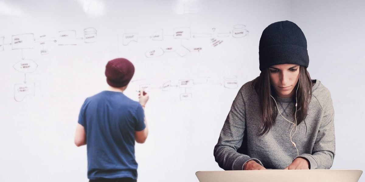 A team actively brainstorming and collaborating around a whiteboard, developing new design models.