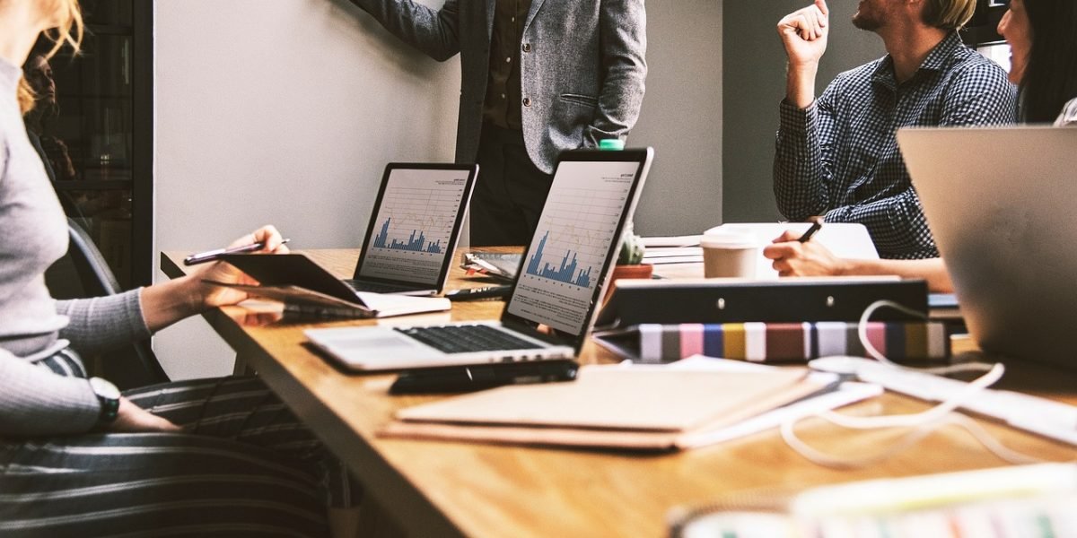 A business team in a meeting discussing a critical problem, symbolizing the real-world impact of AI hallucinations on operations and reputation.