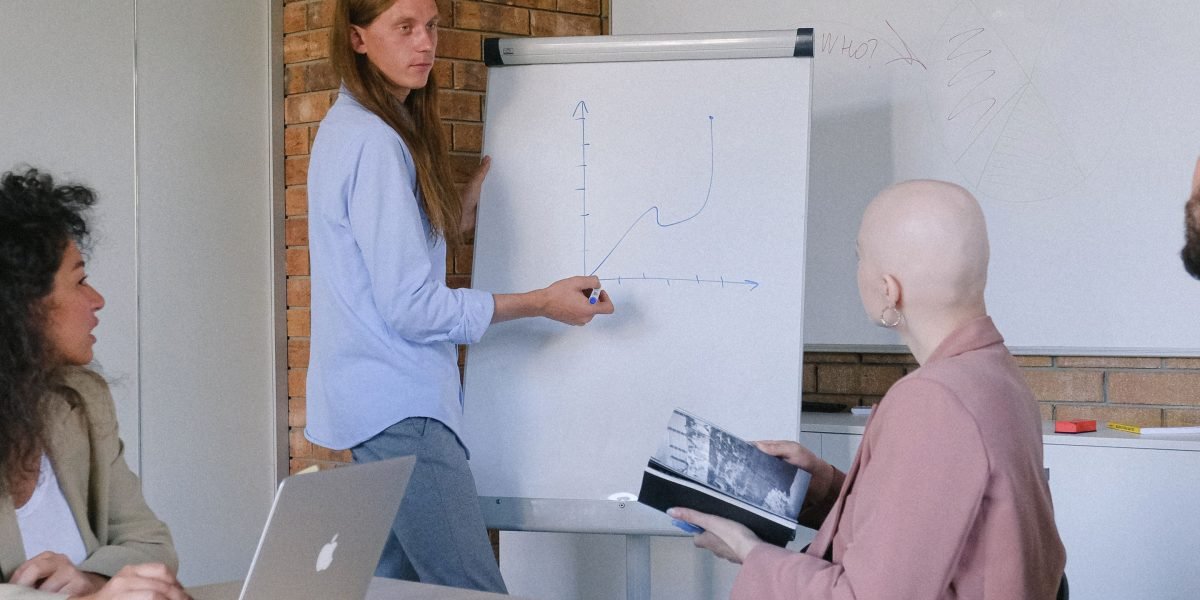A team collaborating, using a whiteboard to outline strategies for ethical AI implementation and continuous improvement.