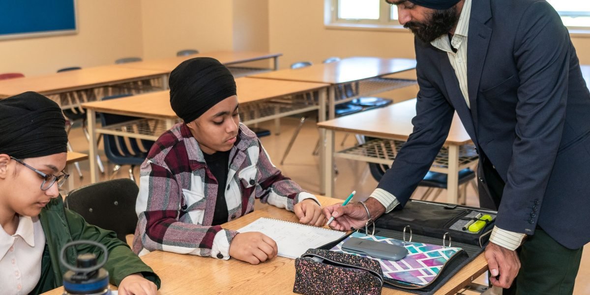 A student actively engaged in learning with a mentor, reflecting the importance of skill development in AI.